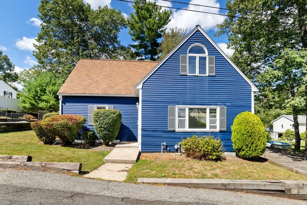 a front view of a house with a garden