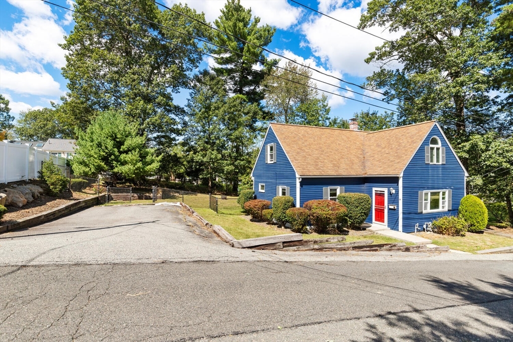 14 Rockwood Road Lynnfield, MA 01940 - Photo 2 of 29 a front view of a house with a yard and potted plants