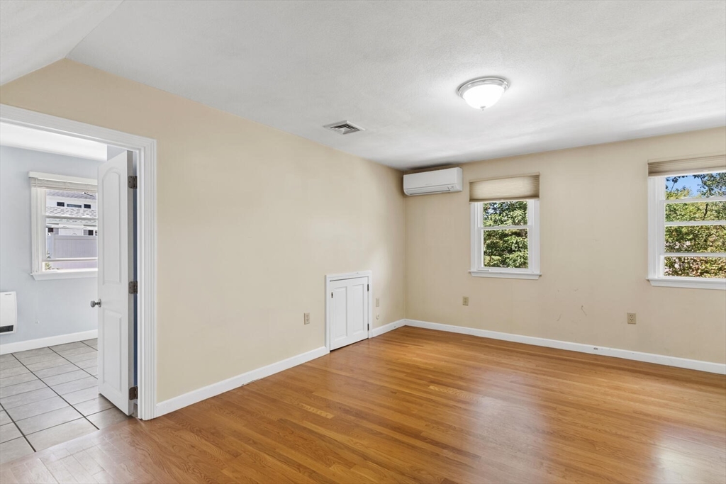 14 Rockwood Road Lynnfield, MA 01940 - Photo 25 of 29 an empty room with wooden floor and windows