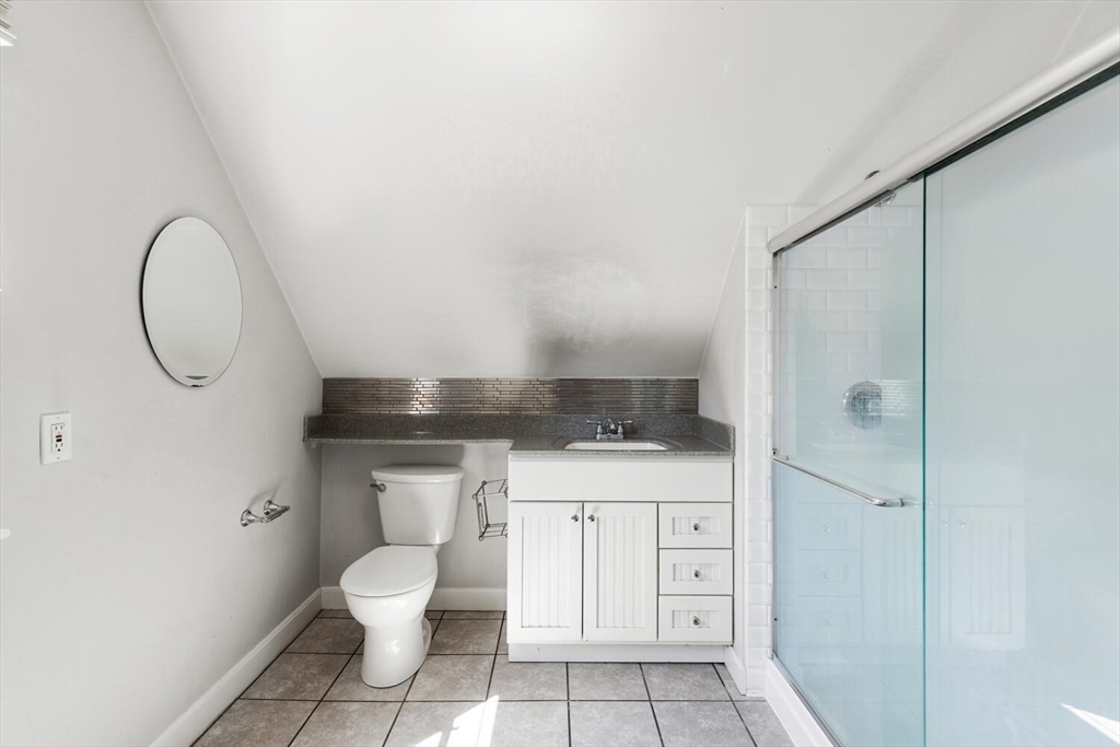 14 Rockwood Road Lynnfield, MA 01940 - Photo 26 of 29 a bathroom with a granite countertop sink a toilet and a mirror