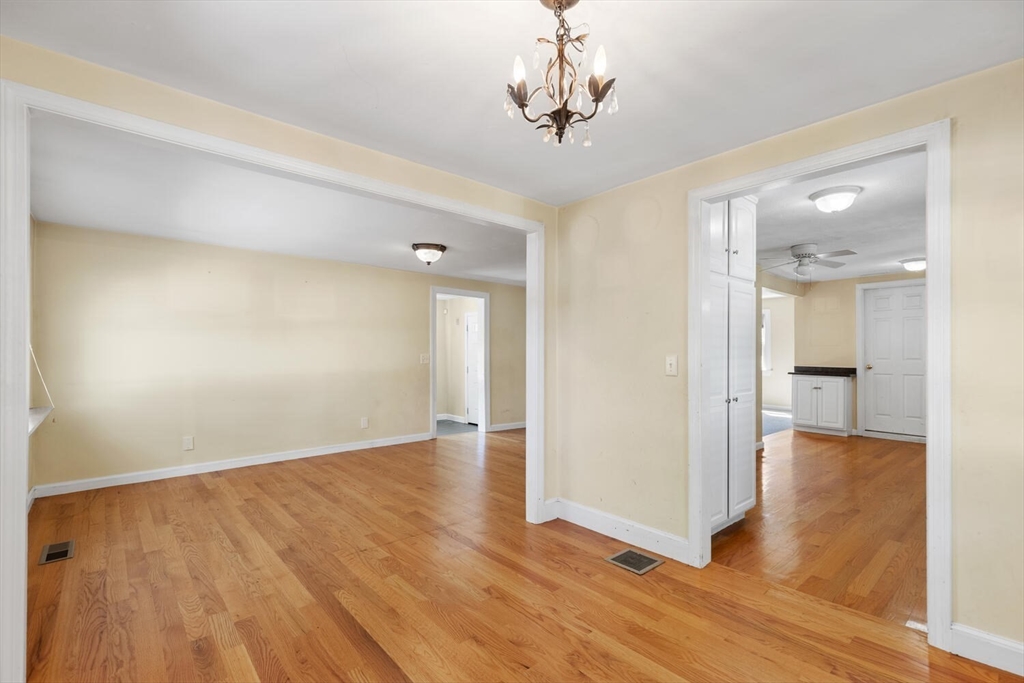 14 Rockwood Road Lynnfield, MA 01940 - Photo 7 of 29 a view of a hallway with wooden floor and chandelier