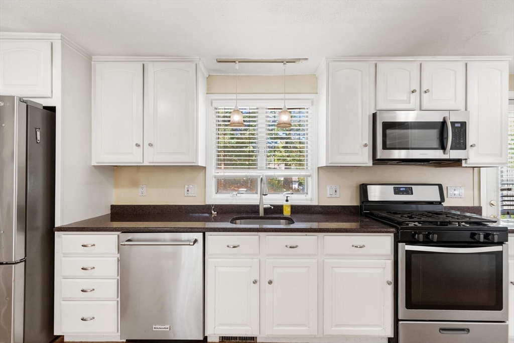14 Rockwood Road Lynnfield, MA 01940 - Photo 10 of 29 a kitchen with granite countertop white cabinets stainless steel appliances and a window