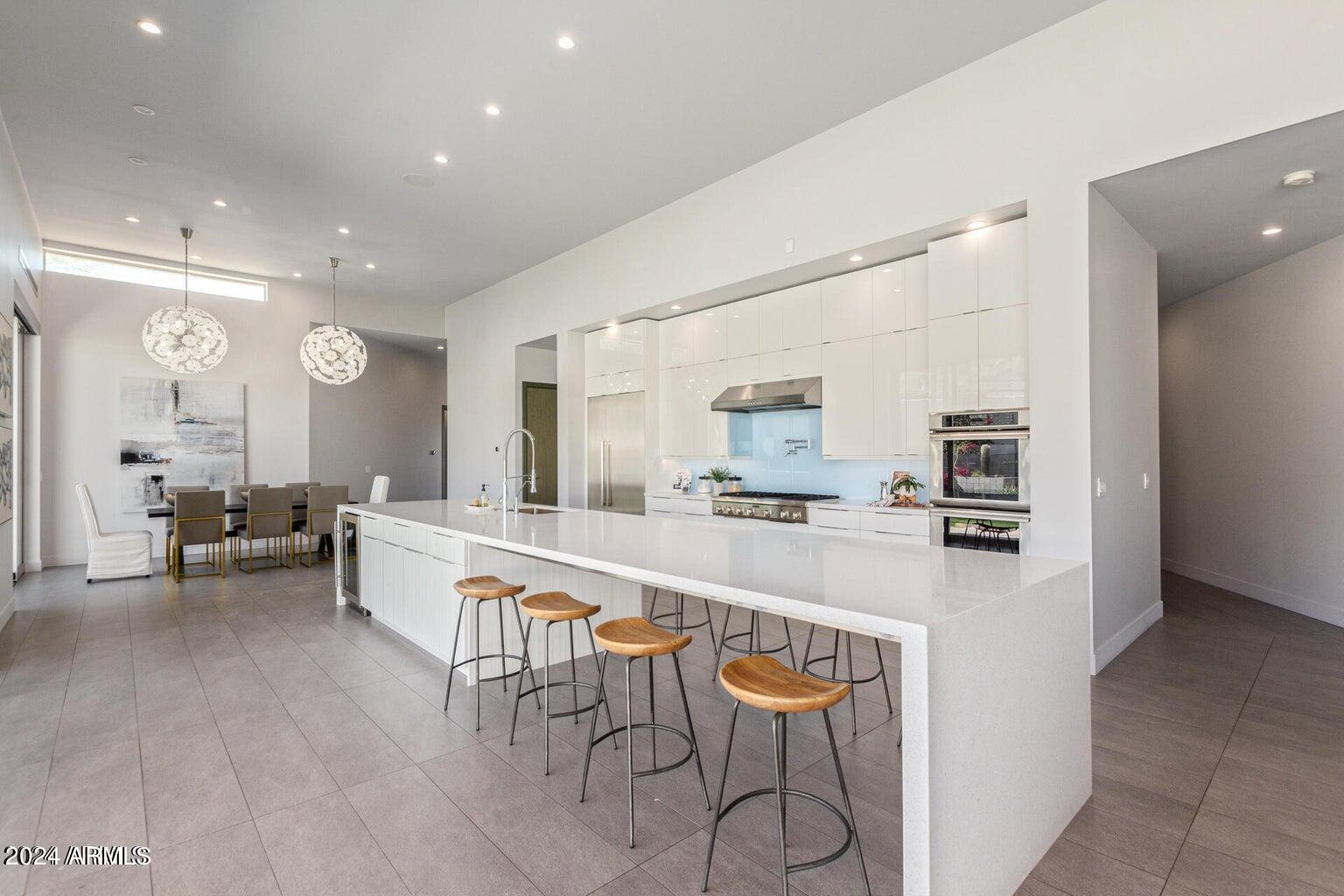5833 North 46th Street Phoenix, AZ 85018 - Photo 11 of 29 a large kitchen with a table and chairs