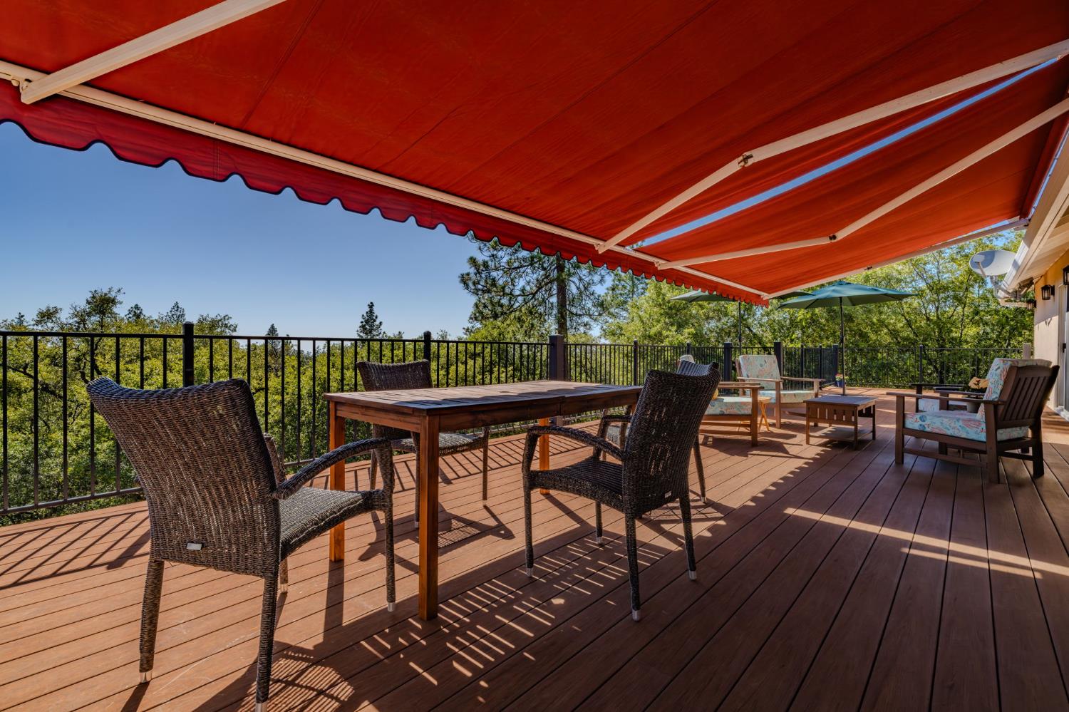 18299 West Clinton Road Jackson, CA 95642 - Photo 14 of 56 a patio with wooden floor a yard tables and chairs