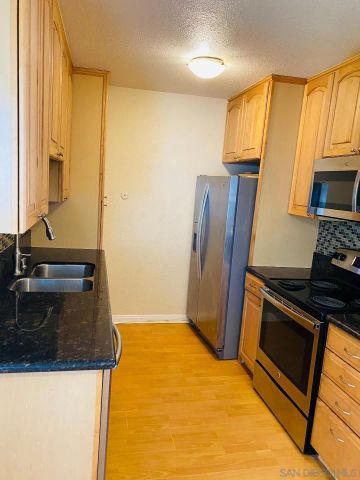 a view of a room with wooden floor and small window