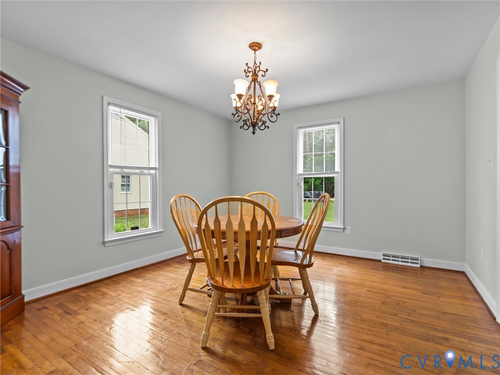 3420 State Rte 656 Powhatan, VA 23139 - Photo 16 of 37 a dining room with furniture a chandelier and wooden floor