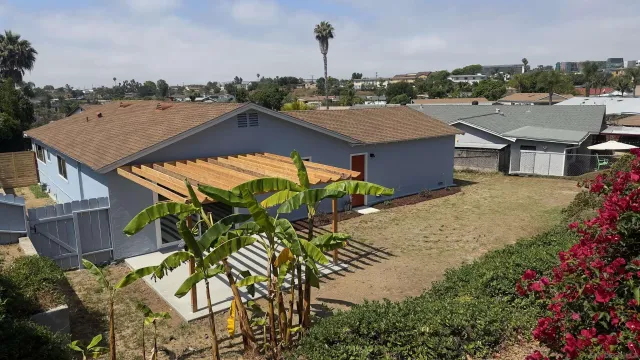 an aerial view of a house with a yard and lake view