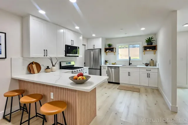 a kitchen with a sink a stove a refrigerator and cabinets