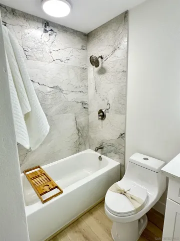 a bathroom with a toilet and a shower