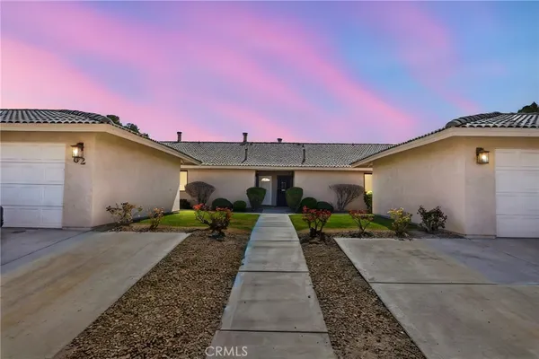 a front view of a house with yard