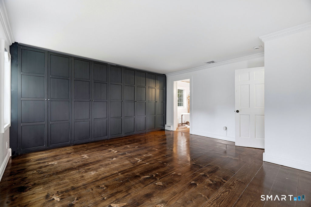 17 Florida Road East Haddam, CT 06423 - Photo 16 of 40 The spacious primary bedroom features an entire wall of closet space & the newly finished gleaming wood floors.