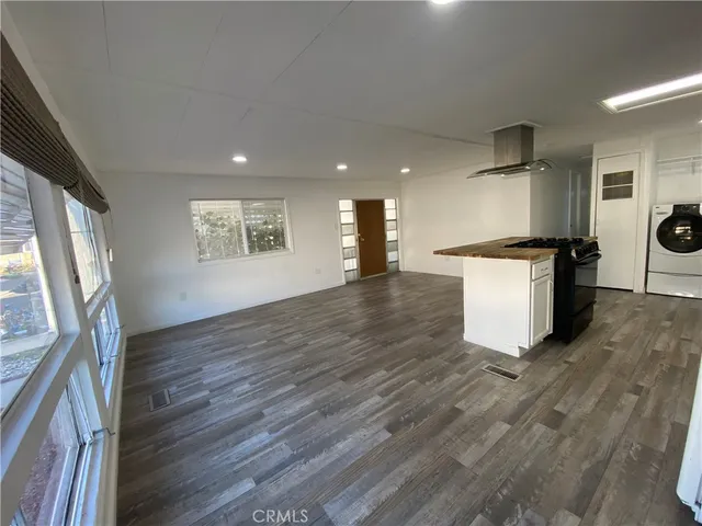 a kitchen with granite countertop a stove and a refrigerator