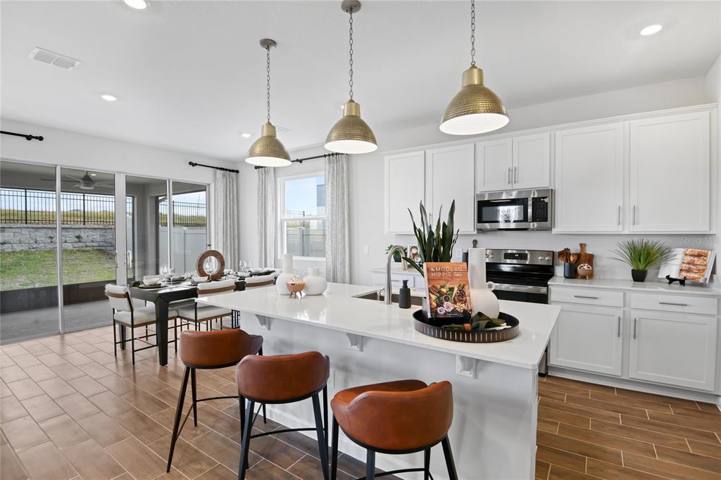 5319 Spring Maiden Circle Apollo Beach, FL 33572 - Photo 5 of 25 a dining room with furniture a window and appliances