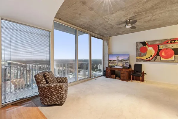 a living room with furniture and a floor to ceiling window