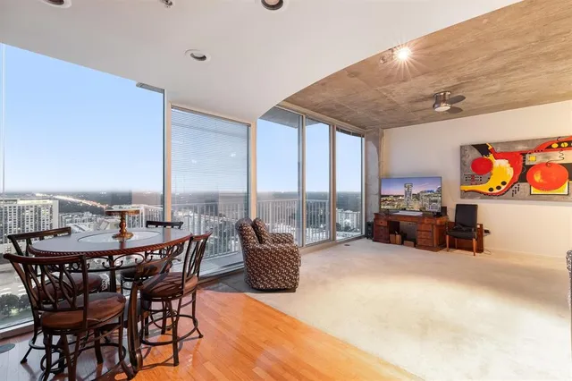 a view of a kitchen with kitchen island a large window cabinets and stainless steel appliances