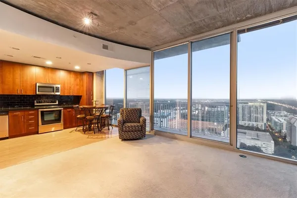 a view of a big room with furniture and floor to ceiling window