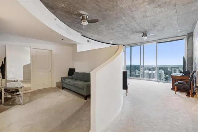 a living room with furniture and a floor to ceiling window