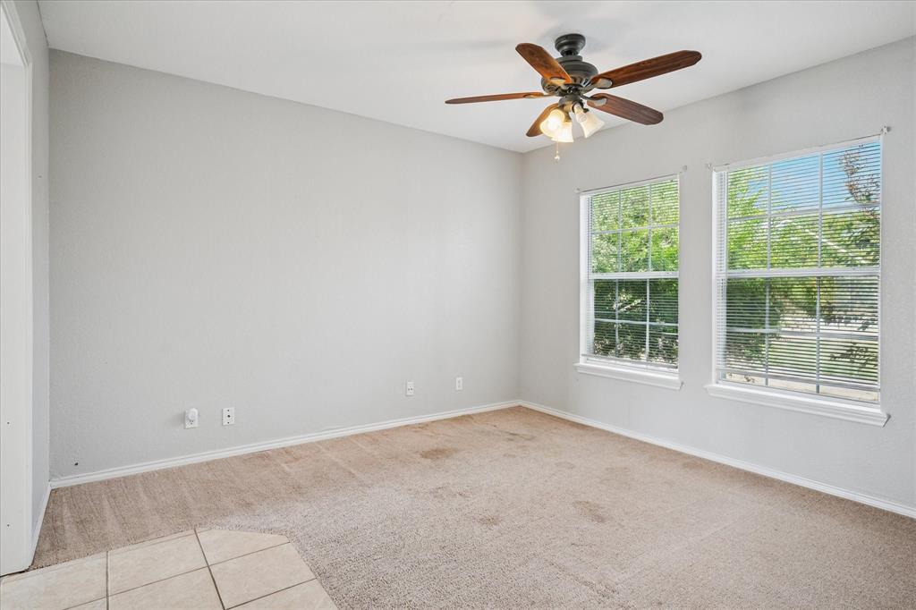 9828 County Road Alvarado, TX 76009 - Photo 11 of 20 an empty room with a window and a fan