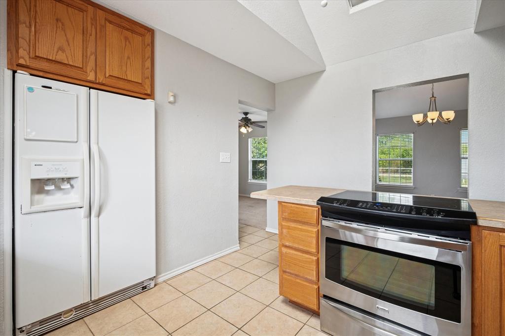 9828 County Road Alvarado, TX 76009 - Photo 7 of 20 a kitchen with a stove and a refrigerator