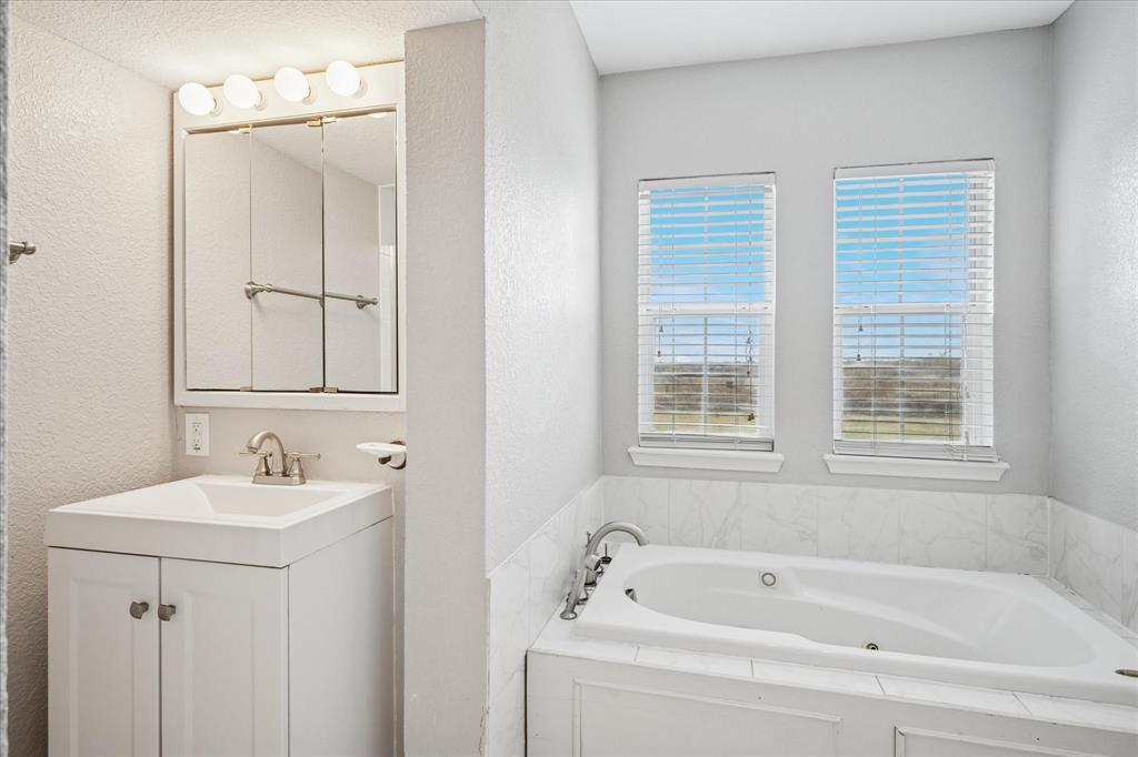 9828 County Road Alvarado, TX 76009 - Photo 9 of 20 a white bath tub sitting next to a white sink
