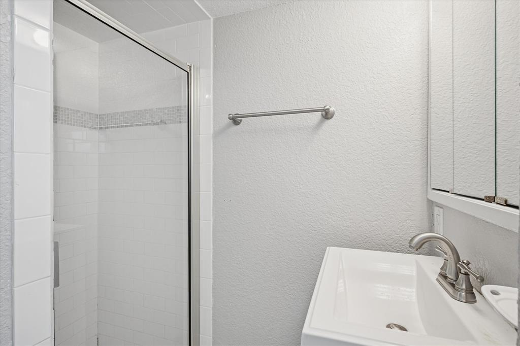 9828 County Road Alvarado, TX 76009 - Photo 10 of 20 a bathroom with a sink and shower