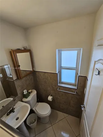 a bathroom with a toilet and a mirror