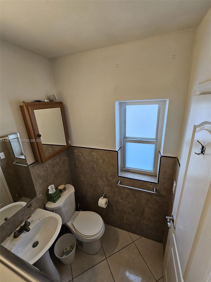 7400 Harding Avenue, Unit 22 Miami Beach, FL 33141 - Photo 12 of 26 a bathroom with a toilet and a mirror