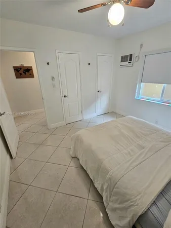 a bedroom with a bed and cabinets