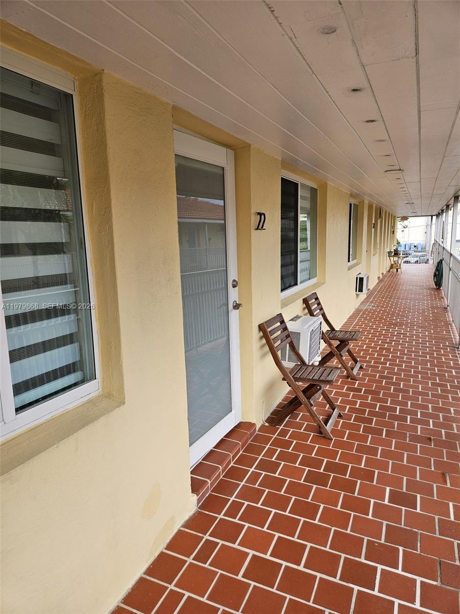 7400 Harding Avenue, Unit 22 Miami Beach, FL 33141 - Photo 15 of 26 a bedroom with a bed and wooden floor