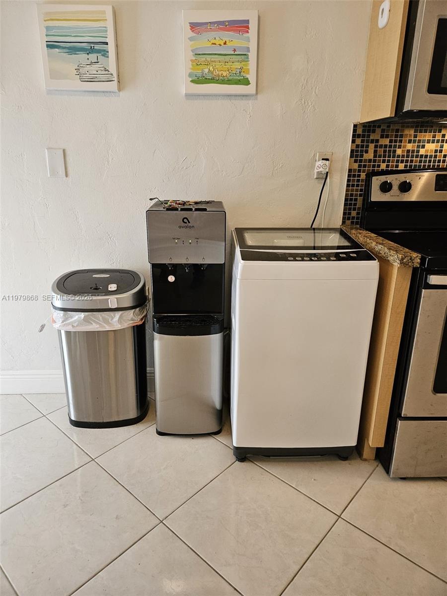 7400 Harding Avenue, Unit 22 Miami Beach, FL 33141 - Photo 18 of 26 a utility room with washer and dryer