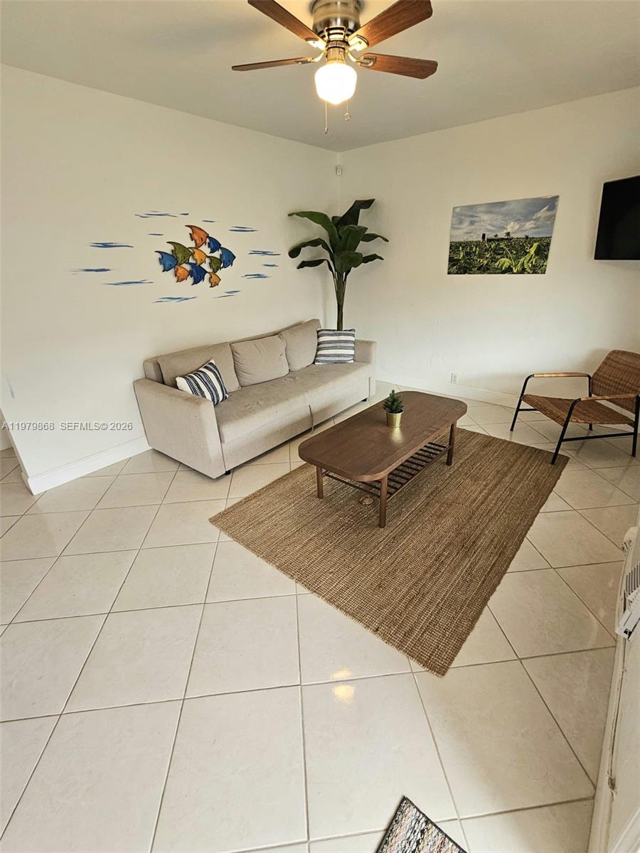 7400 Harding Avenue, Unit 22 Miami Beach, FL 33141 - Photo 2 of 26 a living room with a couch
