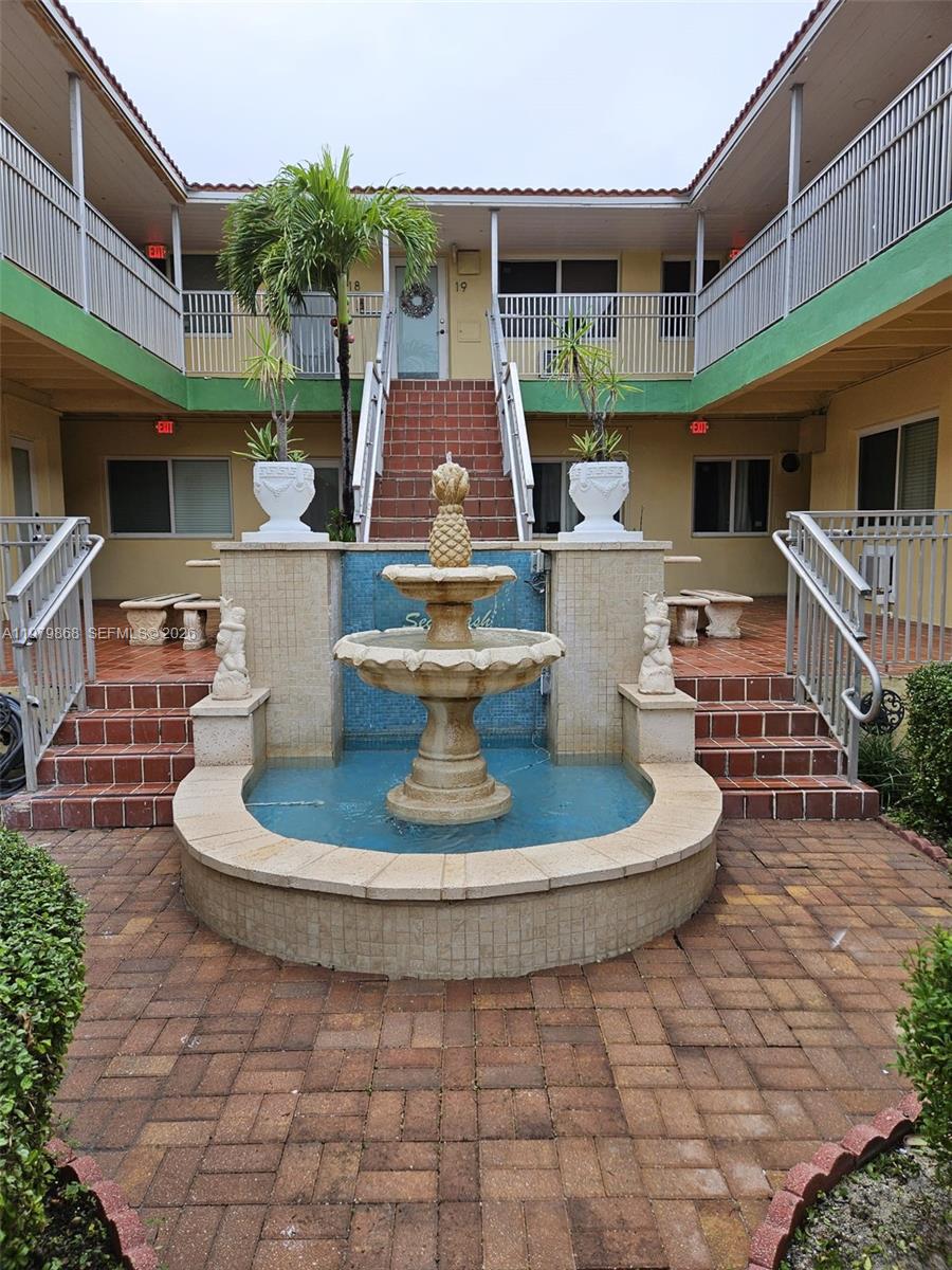 7400 Harding Avenue, Unit 22 Miami Beach, FL 33141 - Photo 23 of 26 a view of a house with backyard sitting area and a garden
