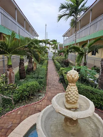a vase of flowers sitting on a table in front of a building