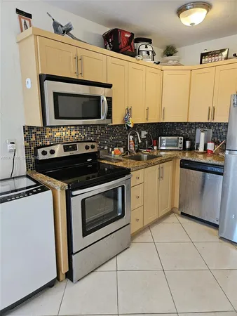 a kitchen with a stove and a microwave