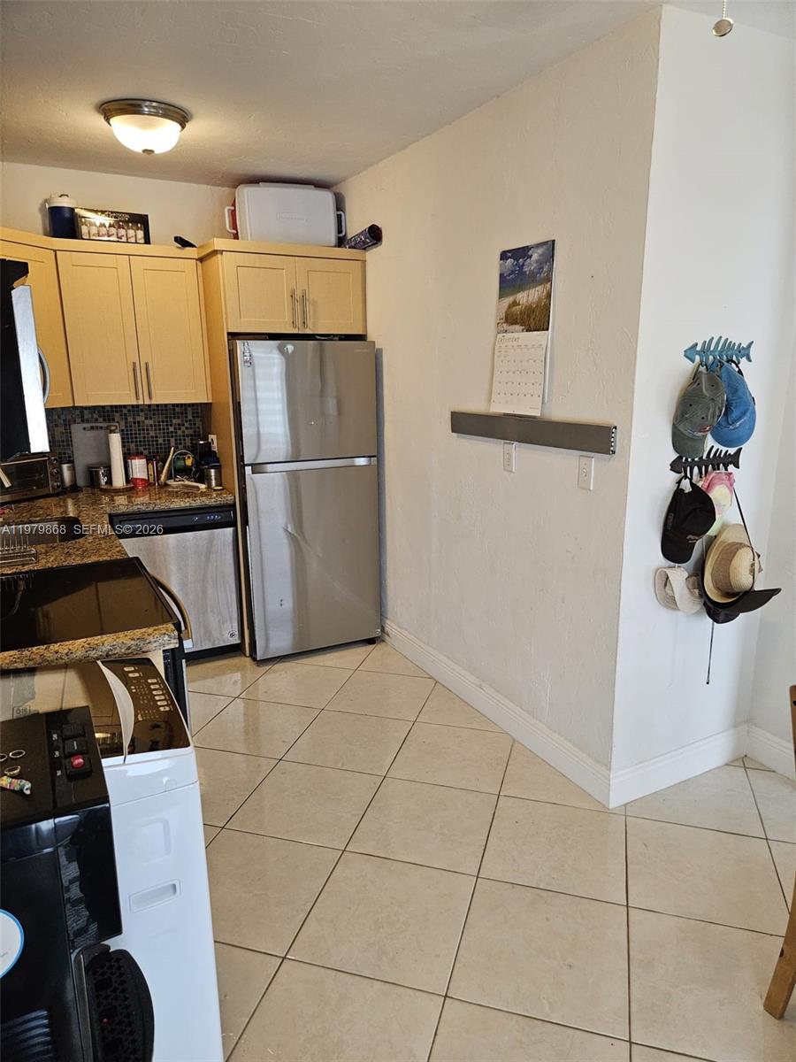 7400 Harding Avenue, Unit 22 Miami Beach, FL 33141 - Photo 6 of 26 a kitchen with a sink appliances and cabinets