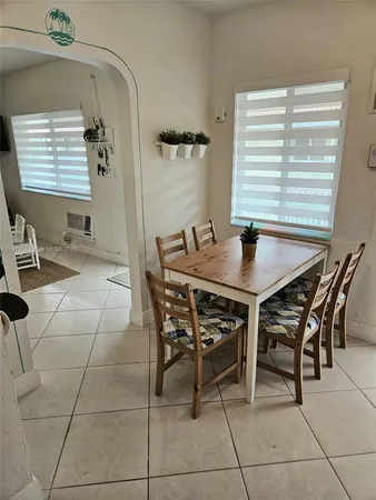 a dining room with a table and chairs