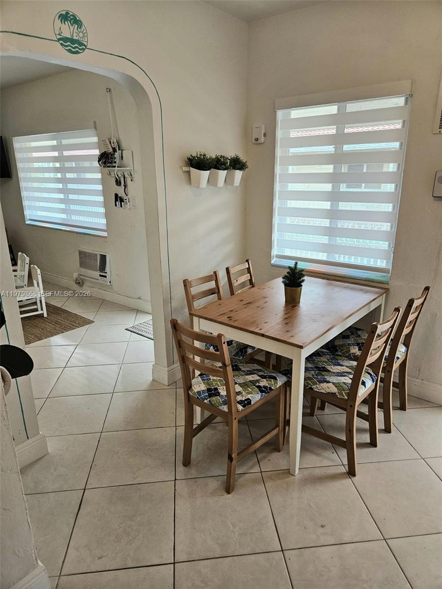 7400 Harding Avenue, Unit 22 Miami Beach, FL 33141 - Photo 10 of 26 a dining room with a table and chairs