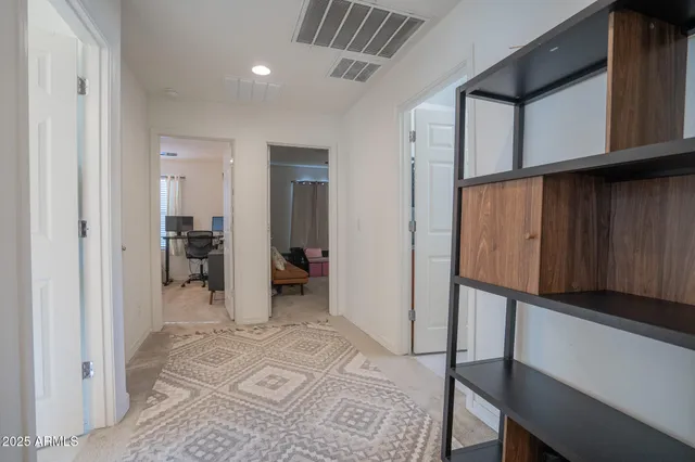 a view of hallway with a window and a livingroom