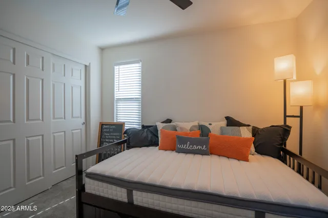 a bedroom with bed and a window