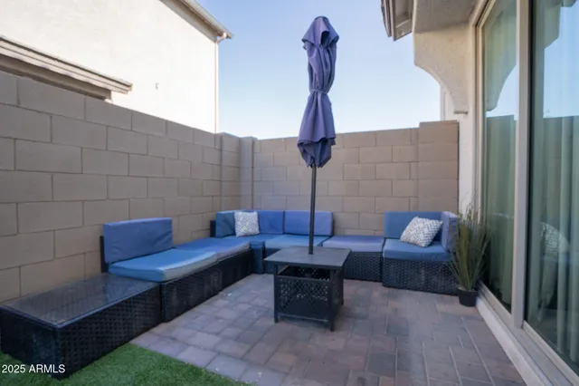 a outdoor sitting area with furniture and wooden floor