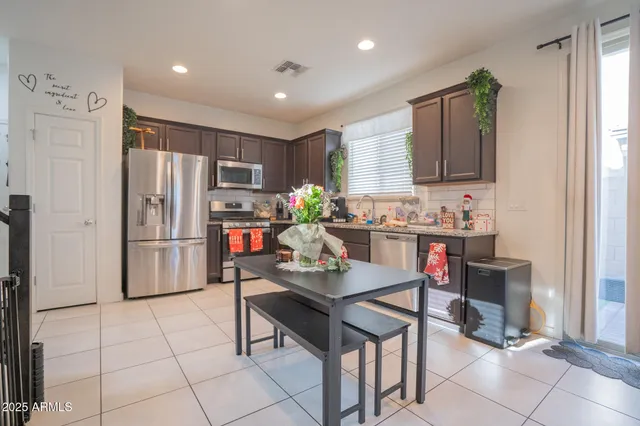 a kitchen with stainless steel appliances a refrigerator and a stove top oven