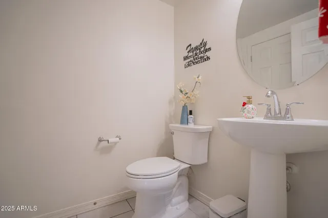a bathroom with a toilet a sink and a mirror