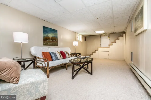 a reading room with furniture and a large window