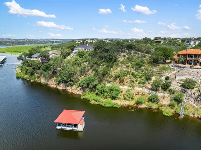 an aerial view of residential houses with outdoor space and swimming pool