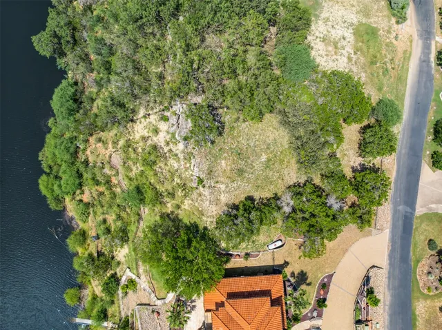 an aerial view of a house with a yard and garden