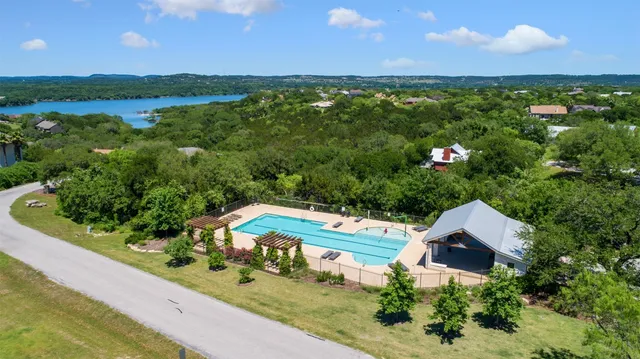 an aerial view of a house with garden space and outdoor seating