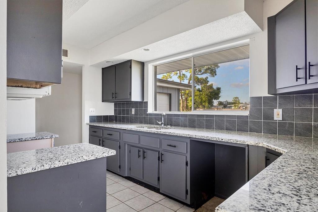 2529 Ednor Street Port Charlotte, FL 33952 - Photo 15 of 23 a kitchen with a sink stove and cabinets