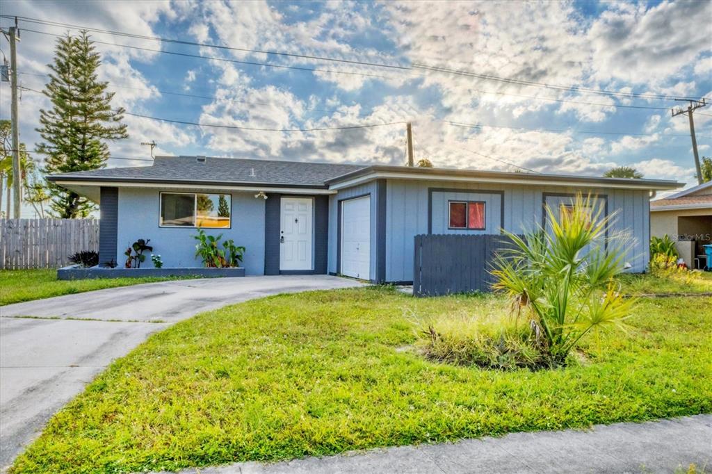 2529 Ednor Street Port Charlotte, FL 33952 - Photo 22 of 23 a front view of house with yard and outdoor seating