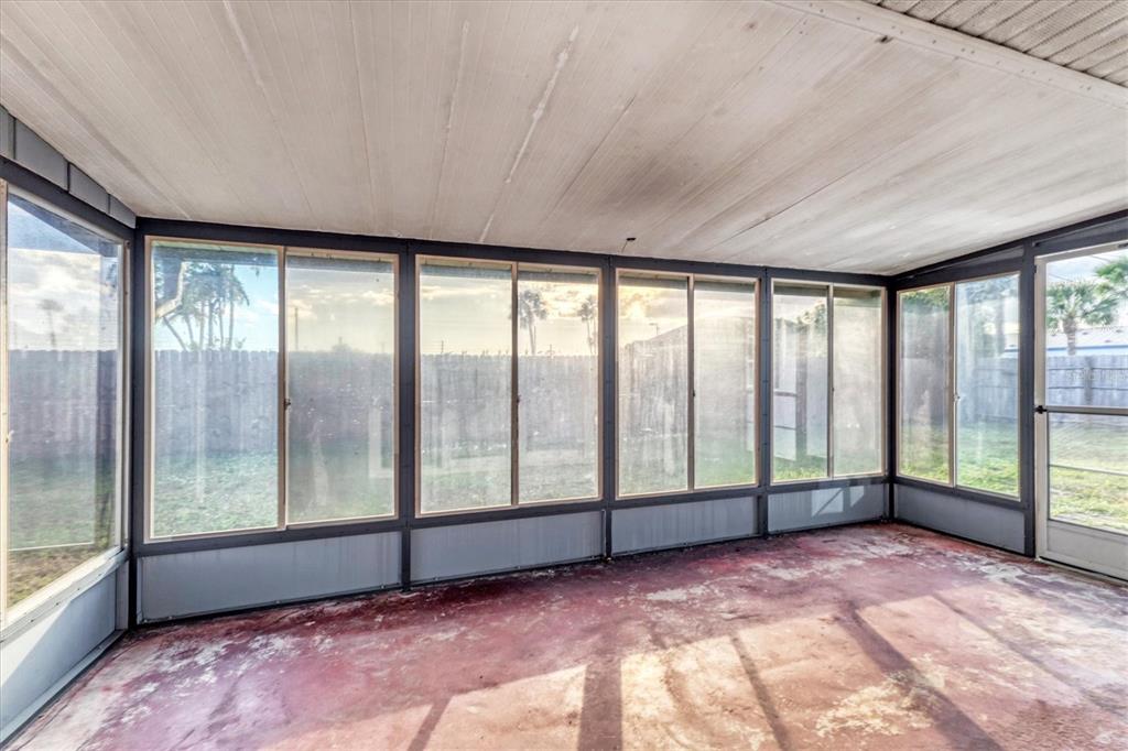 2529 Ednor Street Port Charlotte, FL 33952 - Photo 5 of 23 a view of an empty room with large windows