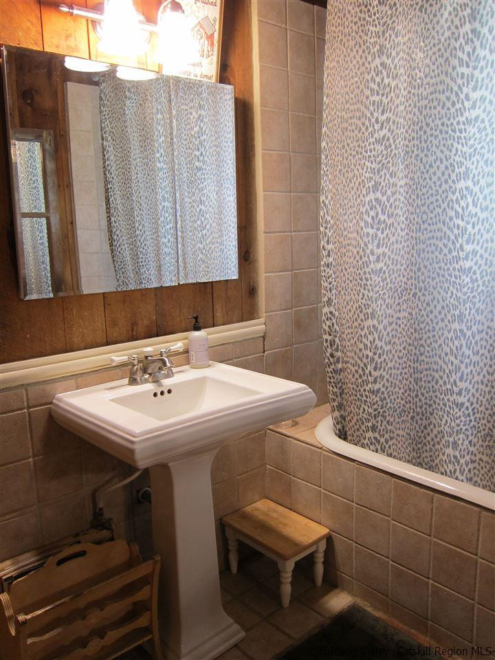 72 Little Deer Road Mount Tremper, NY 12457 - Photo 14 of 21 a bathroom with a sink a toilet and mirror